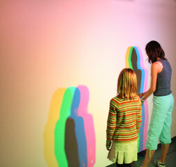 Shadows of different colors of people on the wall....