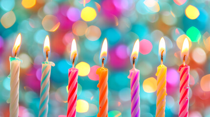 Birthday burning candles against blurred colorful background - 772354972