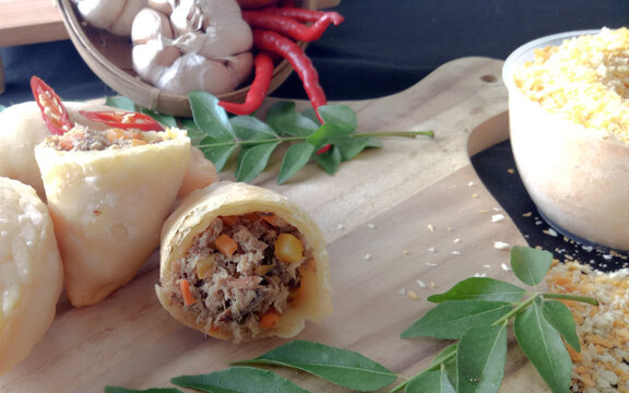 Empanada or Panada, Indonesian traditional snack from Manado, North Sulawesi. Enriched with filled with shredded smoke skipjack tuna fish at the inside. Selective focus.
