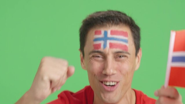 Close up of a man supporting norwegian team