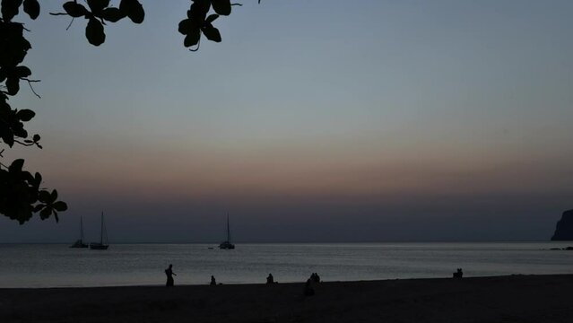 time lapse of beautiful sunset with boat at Farang Beach, Koh Mook. Trang Thailand