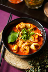 tom yum, soup, in a black bowl, top view, shrimp, mushroom, squid, red chili, coriander, food photography, thai food, tom yum kung, goong, Spicy seafood, prawn