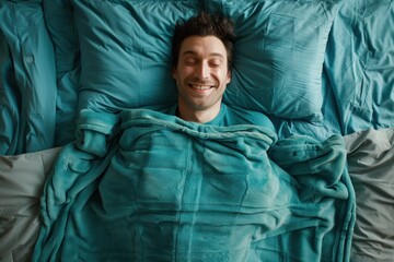 man lying in bed, resting his head on matching pillows and showing a wide - obrazy, fototapety, plakaty