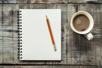 Blank white notebook with a pencil and coffee in a cup next to it on a wooden table