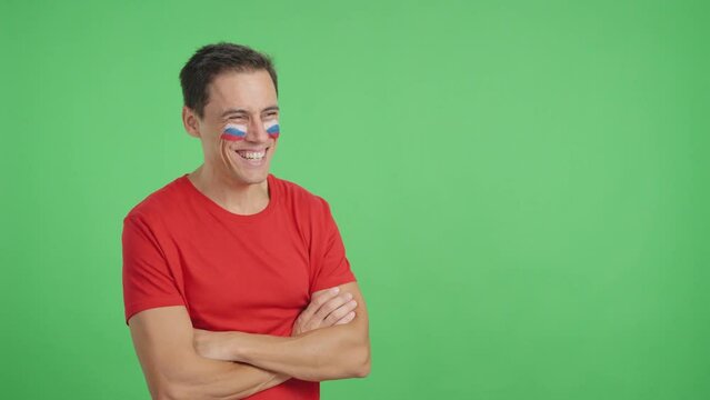 Happy man with russian flag painted on face looking away