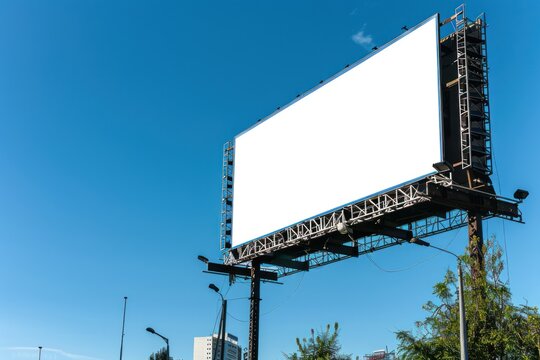 Large empty billboard blank space against clear blue sky. Mockup banner