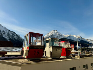 Three historic ski gondolas stand side by side