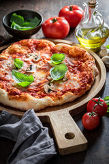 Traditional Italian pizza. Capricciosa pizza with cheese, mushrooms and ham.
