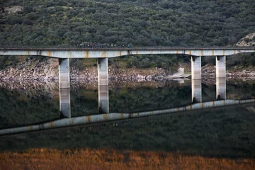 Foto auf Glas Cardenal Bridge over the Tagus River crossed by people walking, Monfragüe Natural Park, Spain © JCDphoto