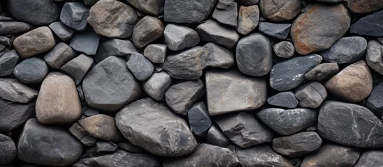 Foto op Plexiglas a close up of a pile of rocks on a wall © AkuAku