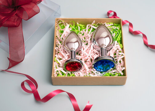 Gift from a sex shop. Metal anal plugs included in the package. Sex concept.