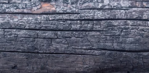 Fotobehang Burnt wooden Board texture. Halloween backdrop. Burned scratched hardwood surface. Smoking wood black plank background © zwiebackesser