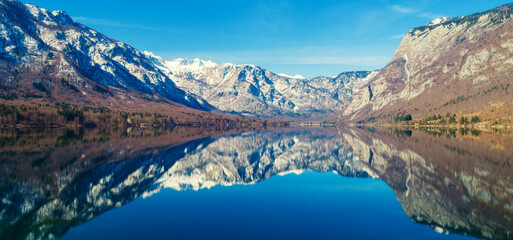 Fototapeta na wymiar Mountain lake with reflection. Nature landscape. Lake Bohinj, Slovenia, Europe. Horizontal banner