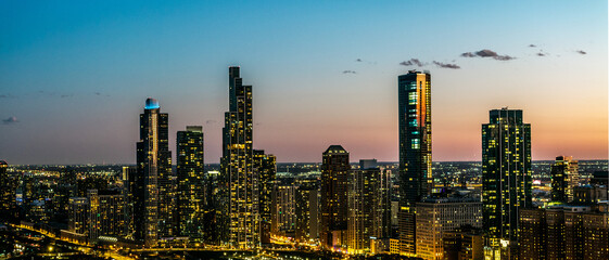 Drone view of a of a panoramic of the downtown Chicago city skyline during dusk time 