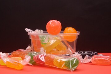 A box full of jelly candy with lollipop standing