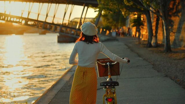 Riverside Stroll with Bicycle at Sunset