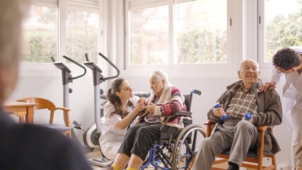 Physiotherapists talking to senior people while exercising in geriatrics
