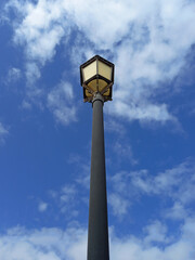 Fototapeta na wymiar Classic street lamp under blue sky. View from below of Walkway garden ground lamp. Outdoor vintage lamppost.