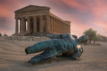 Sunset with Statue of Icarus fallen in front of the Temple of Concord in Agrigento, Valley of the Temples, Sicily - obrazy, fototapety, plakaty