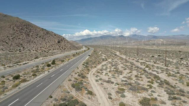 4K Aerials of the windmill farm in Palm Springs, California at the foot of the San Jacinto Mountains, adjacent to Highway 111, which helps provide energy for the Coachella Valley in Riverside County.