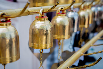 An abstract photo of antique bells in Asia to respect Buddha in the temple. Traveling to Thailand concept.