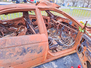 burned-out civilian car. War in Ukraine. Russian invasion of Ukraine. War crimes