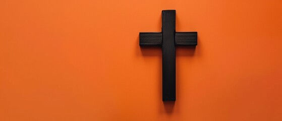 Mystical Black Cross Emerges on Vibrant Orange Wall