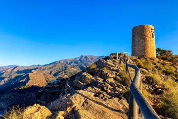 Papier Peint photo Cerro Torre Sunset over Mediterranean sea. Historic Torre Vigia De Cerro Gordo, a watchtower looking out for any marauding pirates. La Herradura, Andulasia, Southern Spain