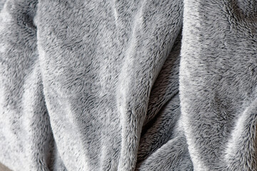 Soft gray fleece material. Warm delicate plaid fabric, fabric texture with folds and wrinkles