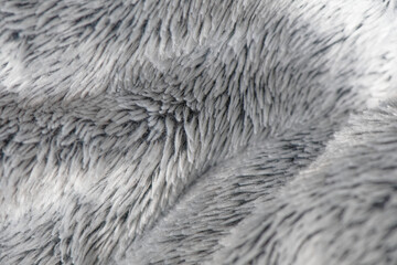 Soft gray fleece material. Warm delicate plaid fabric, fabric texture with folds and wrinkles