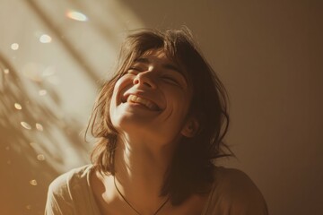 Joyful young person laughing in warm light with a soft smile, conveying happiness and positivity.