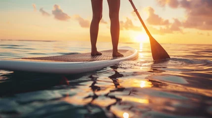 Foto op Plexiglas woman balancing on a paddle board © Anak