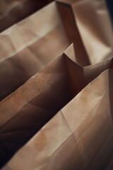 Several brown paper bags arranged neatly on a table. Suitable for packaging and recycling concepts