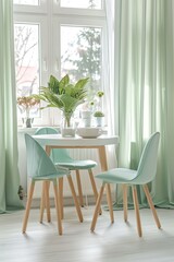 Bright dining area with mint-colored chairs and round wooden table