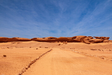 Steine und Sand in einmaliger Formation sind neben der Straße auf dem Weg nach Swakopmung zu sehen