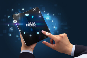Businessman holding a foldable smartphone, social media concept