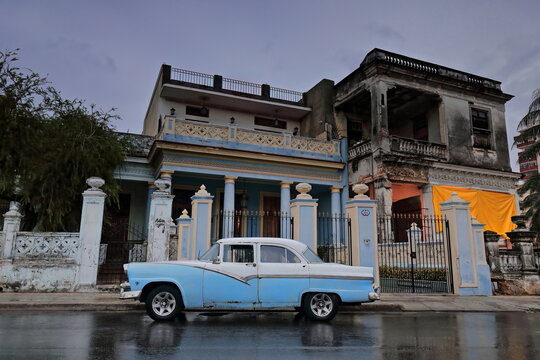 Old green almendron car -1955 Ford classic- stationed on Calle Linea Street in the aftermath of a strong rainstorm. Havana-Cuba-130