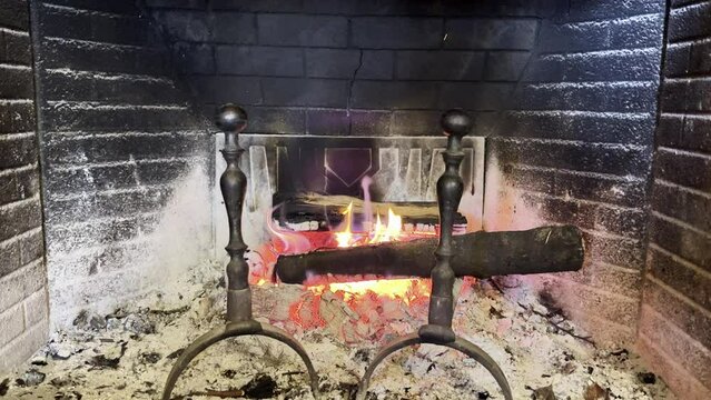 Illuminated wood burning fireplace in a romantic mountain cabin.
