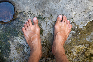 photo of a man's feet wet in water