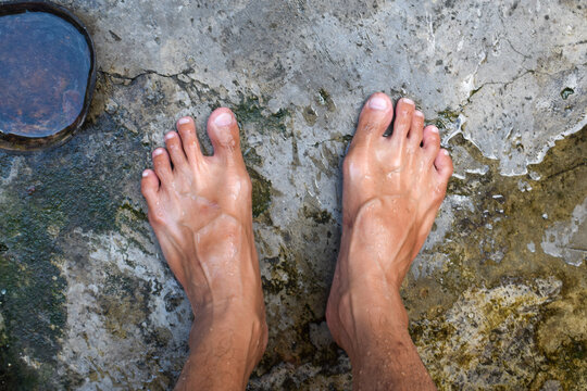 photo of a man's feet wet in water