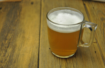 glass of beer on wooden table