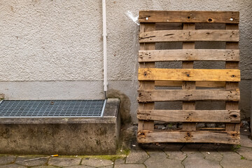 an old wooden euro pallet on the wall of a house