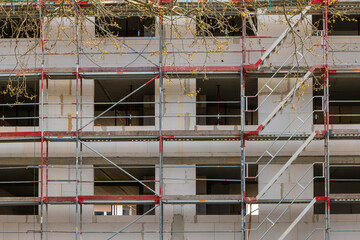 a building under construction with scaffolding and a ladder