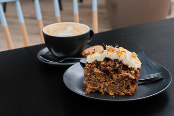 Carrot cake dessert accompanied by a cup of coffee on the table. Favorite delicious coffee cake. Cup of espresso coffee