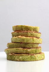 Fried zucchini stack on gray background.