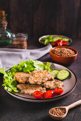 Spicy buckwheat pancakes with slices of cucumber, tomato and lettuce on a plate vertical view