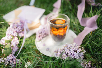 Natural chinese tea with floral in a glass cup. Tea party on a picnic. Herbal. Teatime