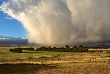 Fototapeta premium A large storm cloud over a field