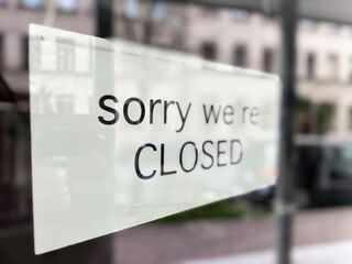 Phrase “Sorry We’re Closed” Written on Glass With Reflection of Local Architecture With Copy Space For Text Overlay, Nightlife in the City, Words and Phrases, Motivational Words