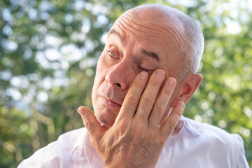 man 60-65 years old, senior crying, suffering, fatigue syndrome eye Asthenopia, eye pain symptoms,...